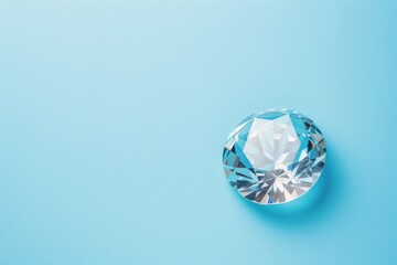 Top view of one beautiful brilliant gemstone with facets isolated on a flat pastel blue background with copy space - obrazy, fototapety, plakaty