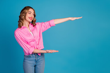 Photo portrait of pretty young girl hold look empty space show measure wear trendy pink outfit...