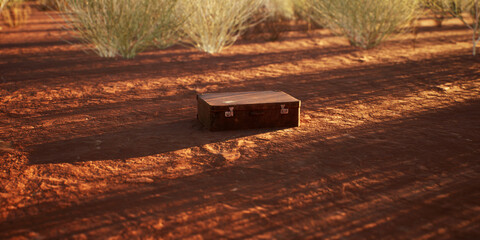Lost vintage leather suitcase on rocky ground in sunny desolate desert. - 775370050