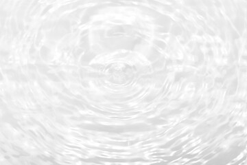 White water with ripples on the surface. Defocus blurred transparent white colored clear calm water surface texture with splashes and bubbles. Water waves with shining pattern texture background
