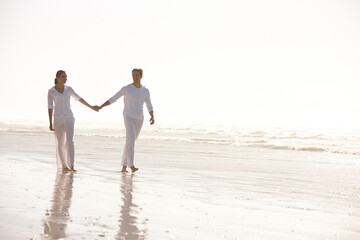 Couple, sea and holding hands while walking on beach, travel and commitment with trust and bonding...