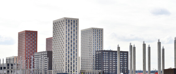 Concrete piles against the background of new buildings