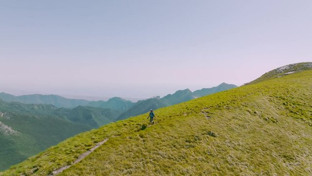 Trail runner running in the mountains, aerial view