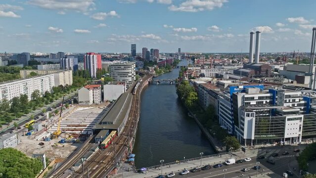 Aerial Drone shot of residential buildings on the bank of spree river in the Friedrichshain neighborhood of Berlin, Germany . 