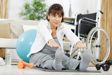 Fototapeta premium happy disable woman exercising at home
