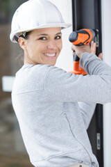 happy young woman with a drill