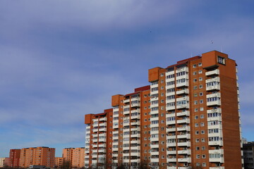 Looking up to red (orange) brick with many windows, Lasnamae, Tallinn, Estonia, Europe. 2024