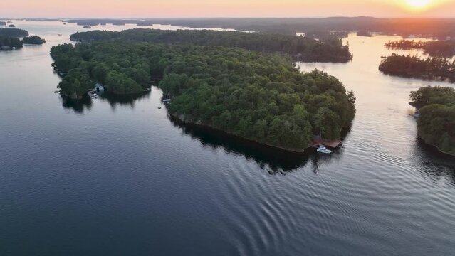 Aerial video of St. Lawrence river in 1000 Islands near US boarder and Hill Island looking away from the 1000 Islands Bridge. at dusk