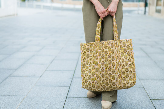 Fashionable woman holding a floral patterned tote bag