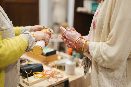 Women trying on bangles at a fashion store