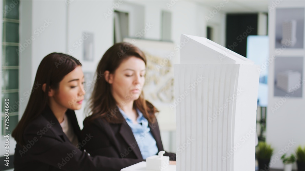 Poster office engineers studying 3d printed model in coworking space, calculating architectural scales and 