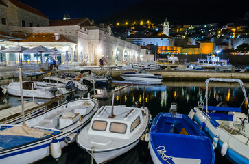 Cozy street and old city walls at night in Dubrovnik, Croatia - 775395067