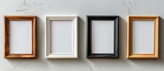 Four empty frames on a wall