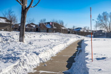 Sidewalk with edge markers used for snow blowing guides