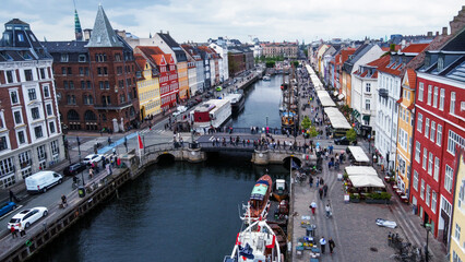 Amazing view on famous NYhavn on Copenhagen , people walking. At right side of channel -...