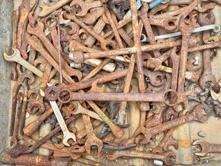 Old rusted wrenches in a workshop - 775403876