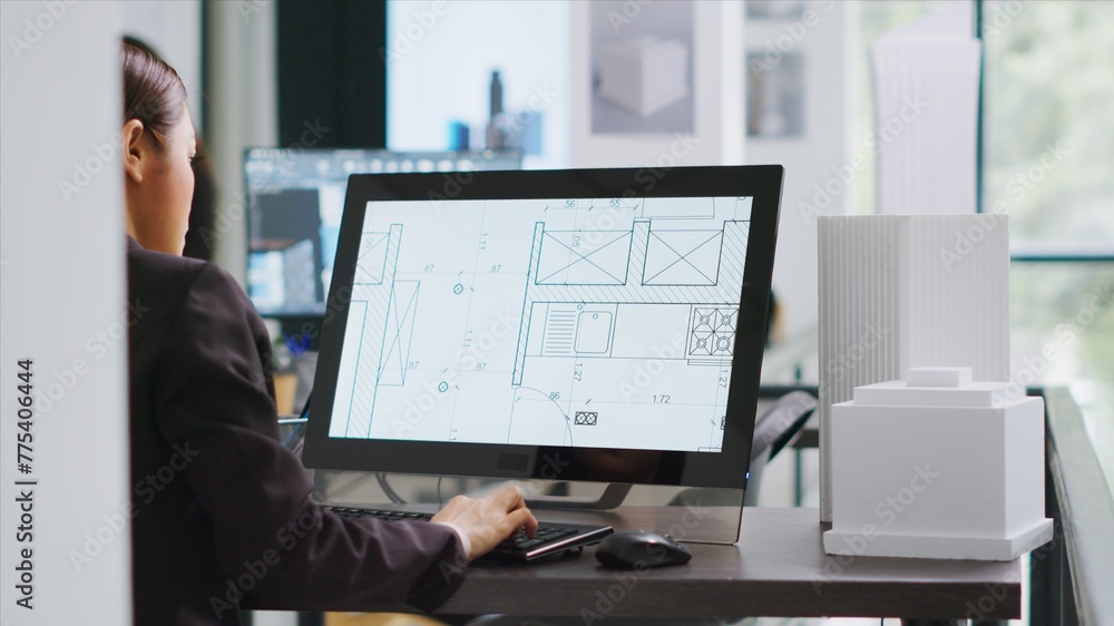 Poster technician operating on cad software to create blueprint for new architectural scaling project, usin