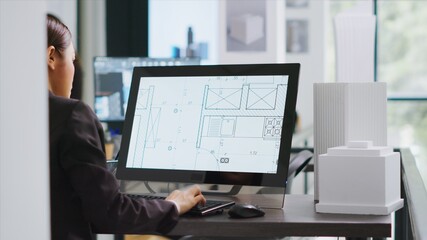 Technician operating on cad software to create blueprint for new architectural scaling project,...