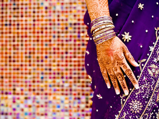 Close up bridal henna tattoo with purple sari