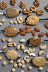Foto op Canvas Tasty nut butters in spoons and raw nuts on gray table, flat lay © New Africa
