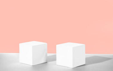Cosmetic powdery background with geometric shapes. Two white cement cubic podiums. Mockup for the...