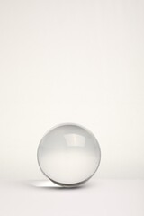Transparent glass ball on white background. Space for text