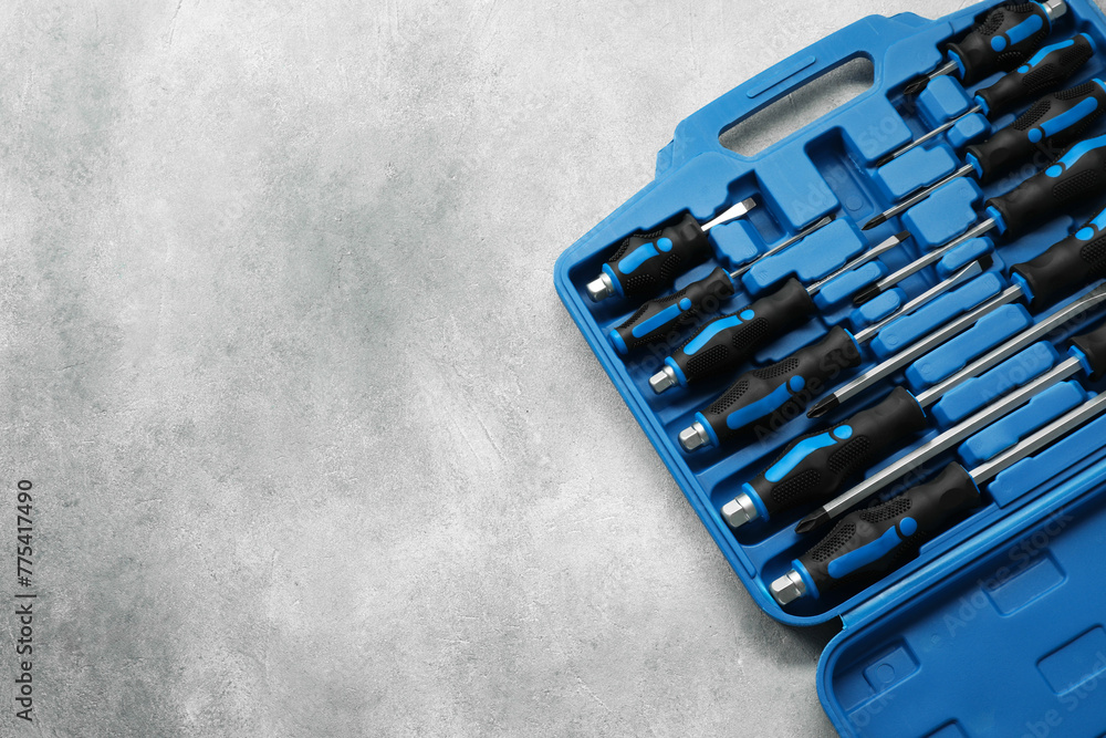 Aufkleber set of screwdrivers in open toolbox on light grey textured table, top view. space for text
