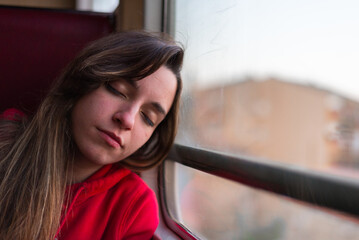 Contemplative woman resting on a train journey