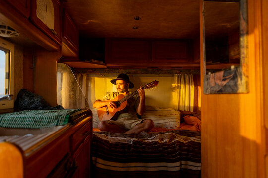 Nomadic Musician Composing in His Motorhome at Sunset