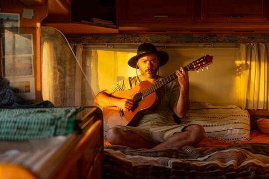 Nomadic Musician Composing in Motorhome at Sunset