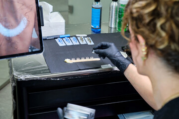 Tattoo artist at work in a modern studio