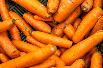 Close-up of Fresh Carrots at Farmers Market Stall, full frame. Colorful display of ripe, orange...