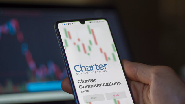 April 04th 2024. The logo of Charter Communications on the screen of an exchange. Charter Communications price stocks, $CHTR on a device.
