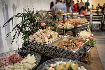 wooden table with stainless steel Richo with various types of food
