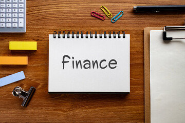 There is notebook with the word Finance. It is as an eye-catching image.