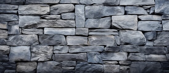 Fototapeta premium Rustic stone wall up close with a red fire hydrant standing in front, creating a striking urban contrast