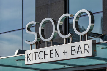 Fototapeta premium Sign of Soco Kitchen + Bar in the downtown district, Toronto, Canada