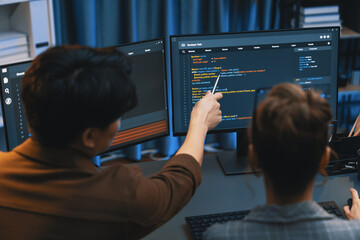 Smart IT developer looking at coding program application on computer screen of online website at...