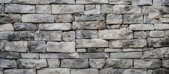 A detailed view of a stone wall in close proximity to a red and yellow fire hydrant