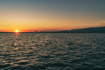 Colorful sunset landscape on the sea and the sun in Izmir, Turkey.