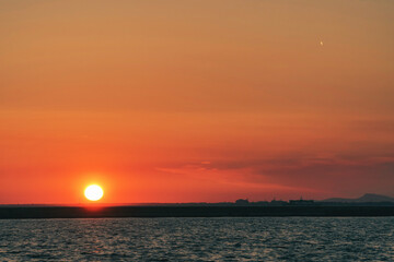 Colorful sunset landscape on the sea and the sun in Izmir, Turkey.