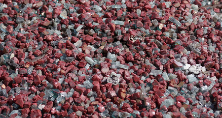 Broken glass and red stones in a gas fire pit