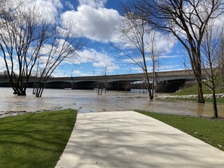 flooded walking trail and bridge over river