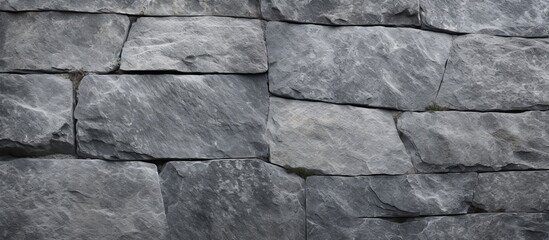 Focusing closely on a textured stone wall where a black and white photo is displayed