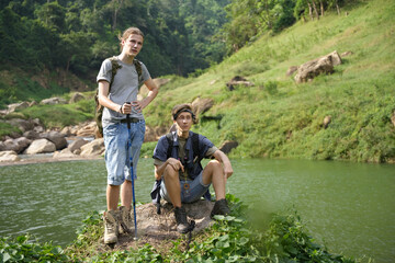 Group of Young man and woman enjoy and fun outdoor lifestyle travel nature forest mountain on summer holiday vacation. FRIENDS IN NATURE ENGAGED IN OUTDOOR ACTIVITIES. Camping concept. 