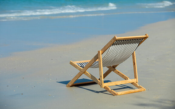 Beach chair with empty sand. Beach with blue sky in summer as vacation, copy space for text