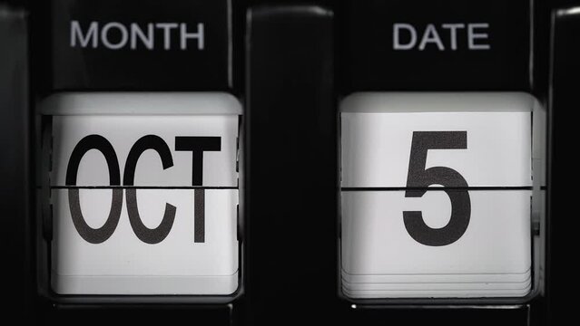 retro flip calendar with a date change from the fourth of October to the fifth of October. daily calendar with a change of days of the month. close up.