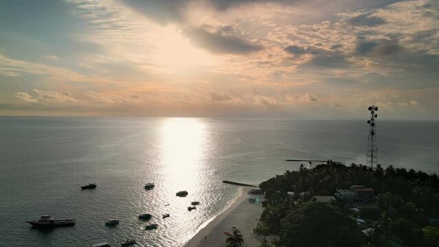 Sunset sky reflecting on Indian Ocean at Fulidhoo island, Maldives, Aerial