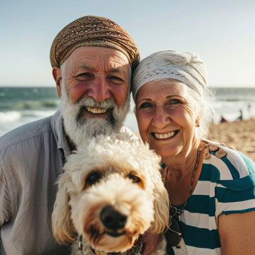 lifestyle photo Happy couple, holding hands and at the beach with a dog in summer for retirement travel. Smile, playful and an elderly man and woman on a walk at the sea with a pet for play and