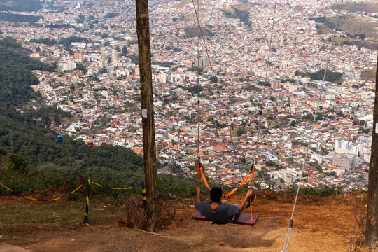 Balan&ccedil;o e Telef&eacute;rico no Parque do Cristo - PO&Ccedil;OS DE CALDAS, MG, BRAZIL - JULY 19, 2023: Swing and cable car in Parque do Cristo (Christ Park) in the S&atilde;o Domingos mountains, with a view of the city.